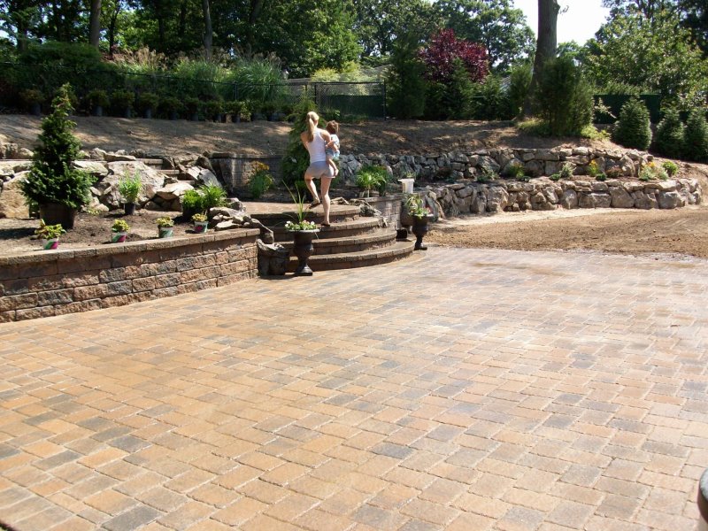 backyard retaining walls with moss rock boulders